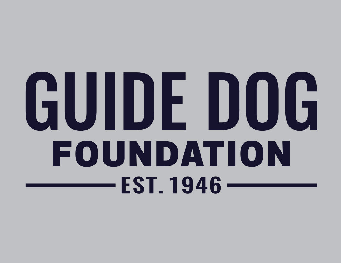 Close up of chest Guide Dog Foundation logo in Navy on a grey backdrop.