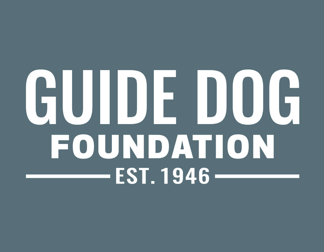 Close up of white Guide Dog Foundation logo with "EST. 1946" underneath on a deep teal background.