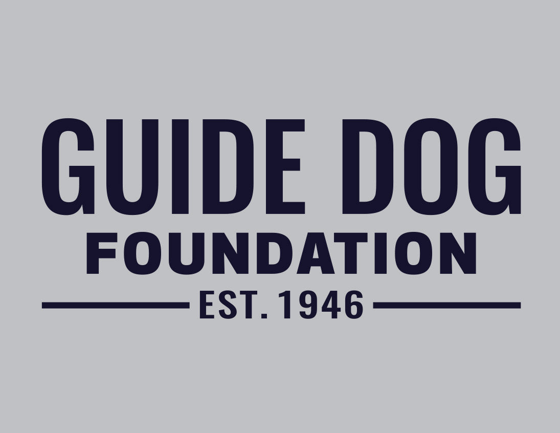 Close up of chest Guide Dog Foundation logo in Navy on a grey backdrop. 