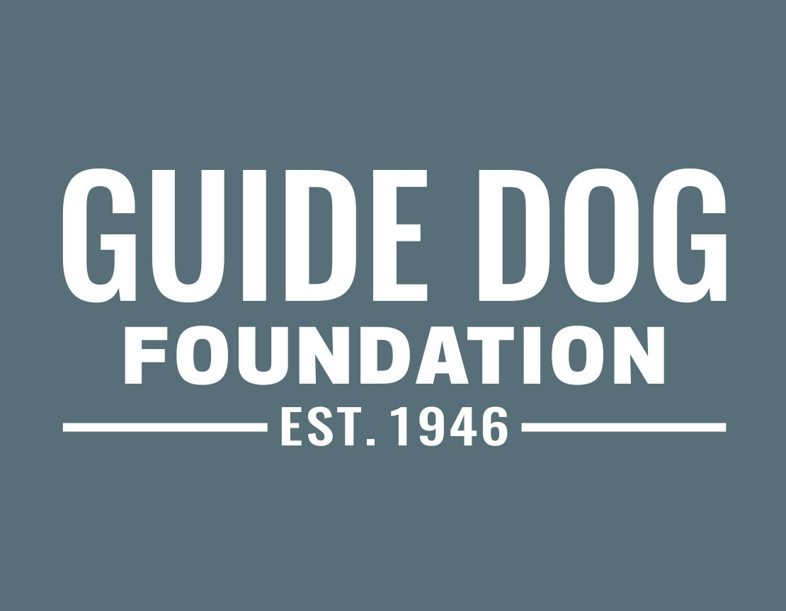 Close up of white Guide Dog Foundation logo with "EST. 1946" underneath on a deep teal background. 