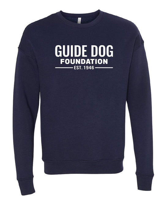 Long sleeve Navy crewneck sweatshirt with "Guide Dog Foundation" logo across the chest in white with "EST. 1946" underneath. 