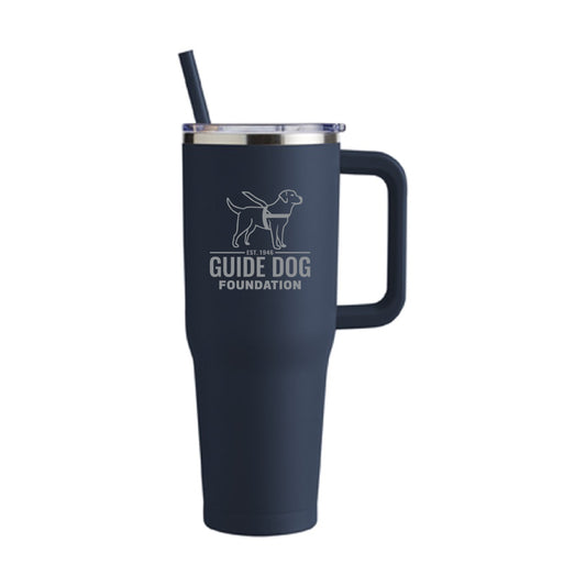 Sleek navy blue 20oz tumbler with stainless steel cut out of Guide Dog Foundation's logo on the front. A navy blue straw and clear lid.